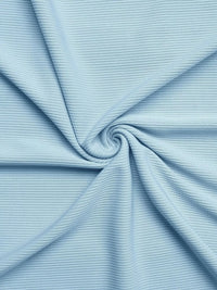 Close-up of light blue ribbed fabric with a swirl pattern