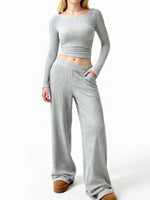 Person wearing a gray ribbed knit outfit on a white background