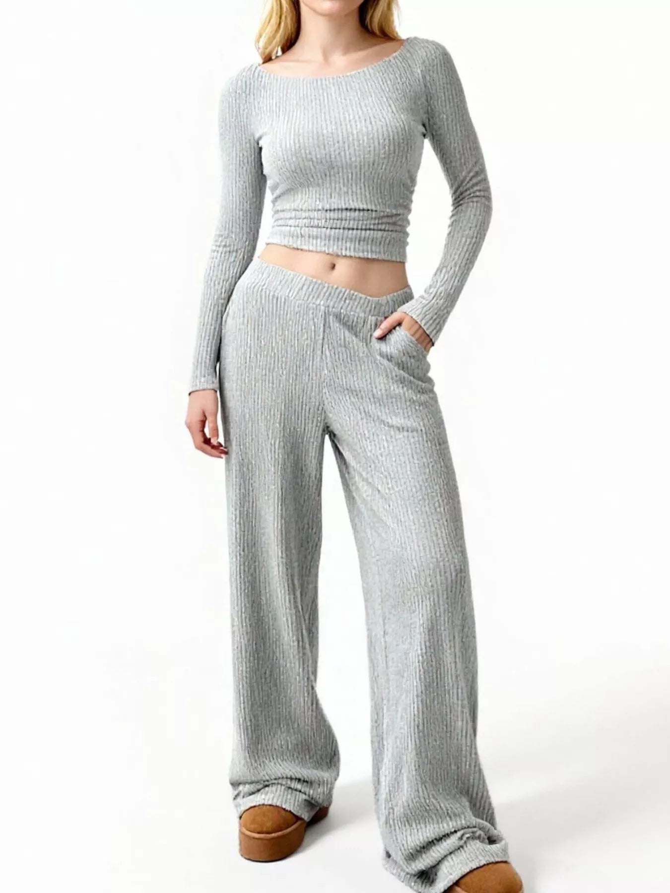 Person wearing a gray ribbed knit outfit on a white background