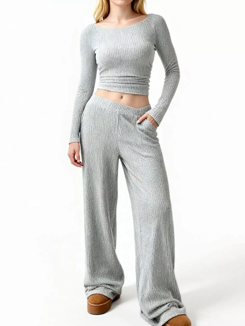 Person wearing a gray ribbed knit outfit on a white background