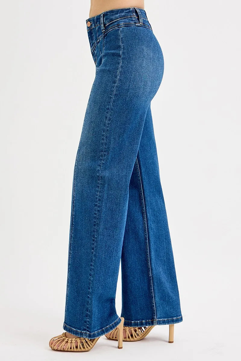 Blue jeans worn by a person on a white background