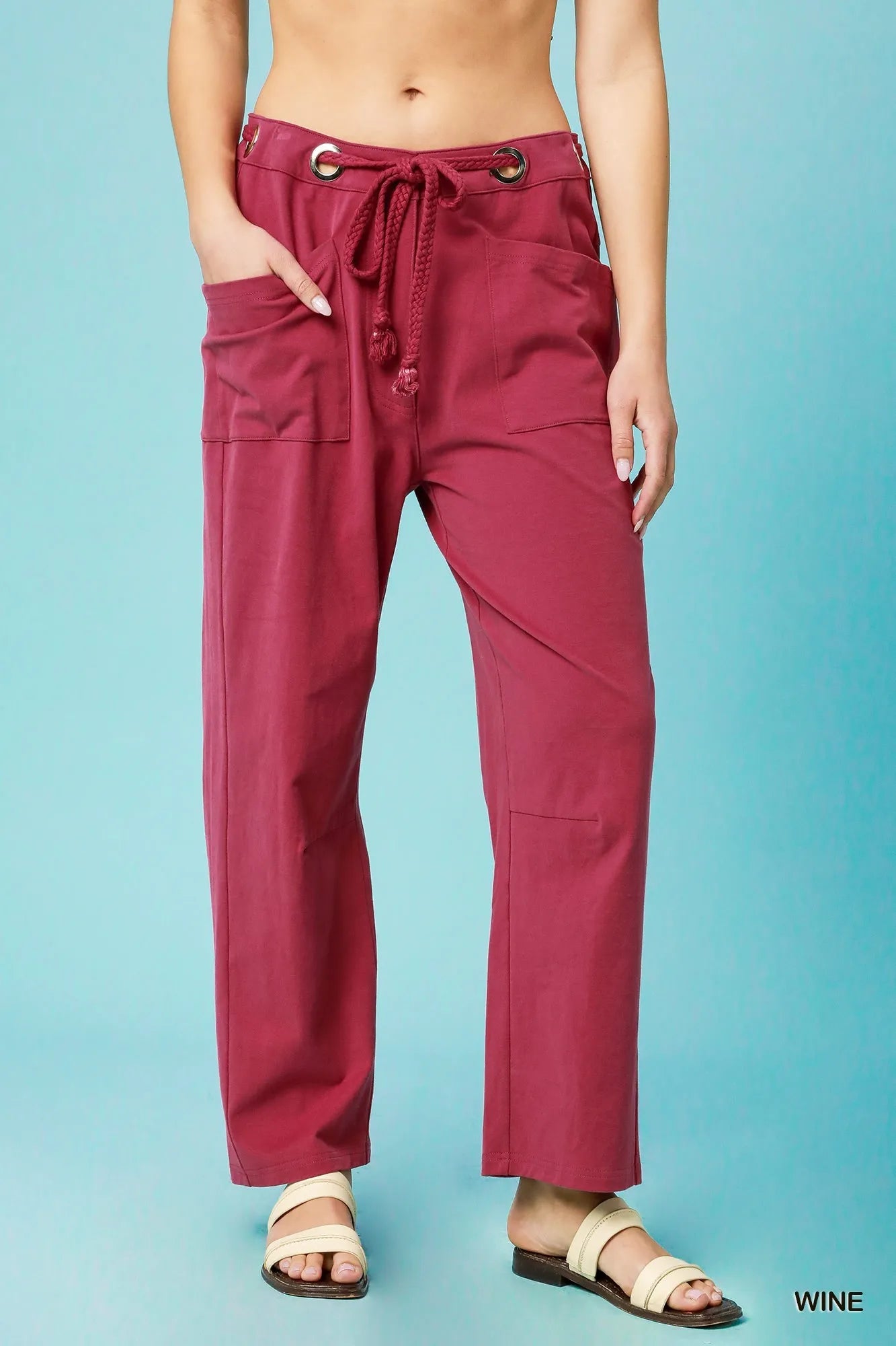 Red pants worn by a person on a blue background