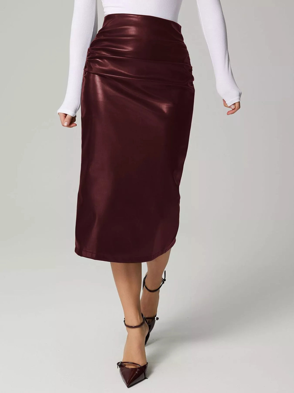 Burgundy satin skirt worn by a person on a light gray background