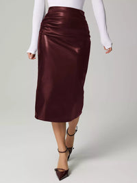 Burgundy satin skirt worn by a person on a light gray background