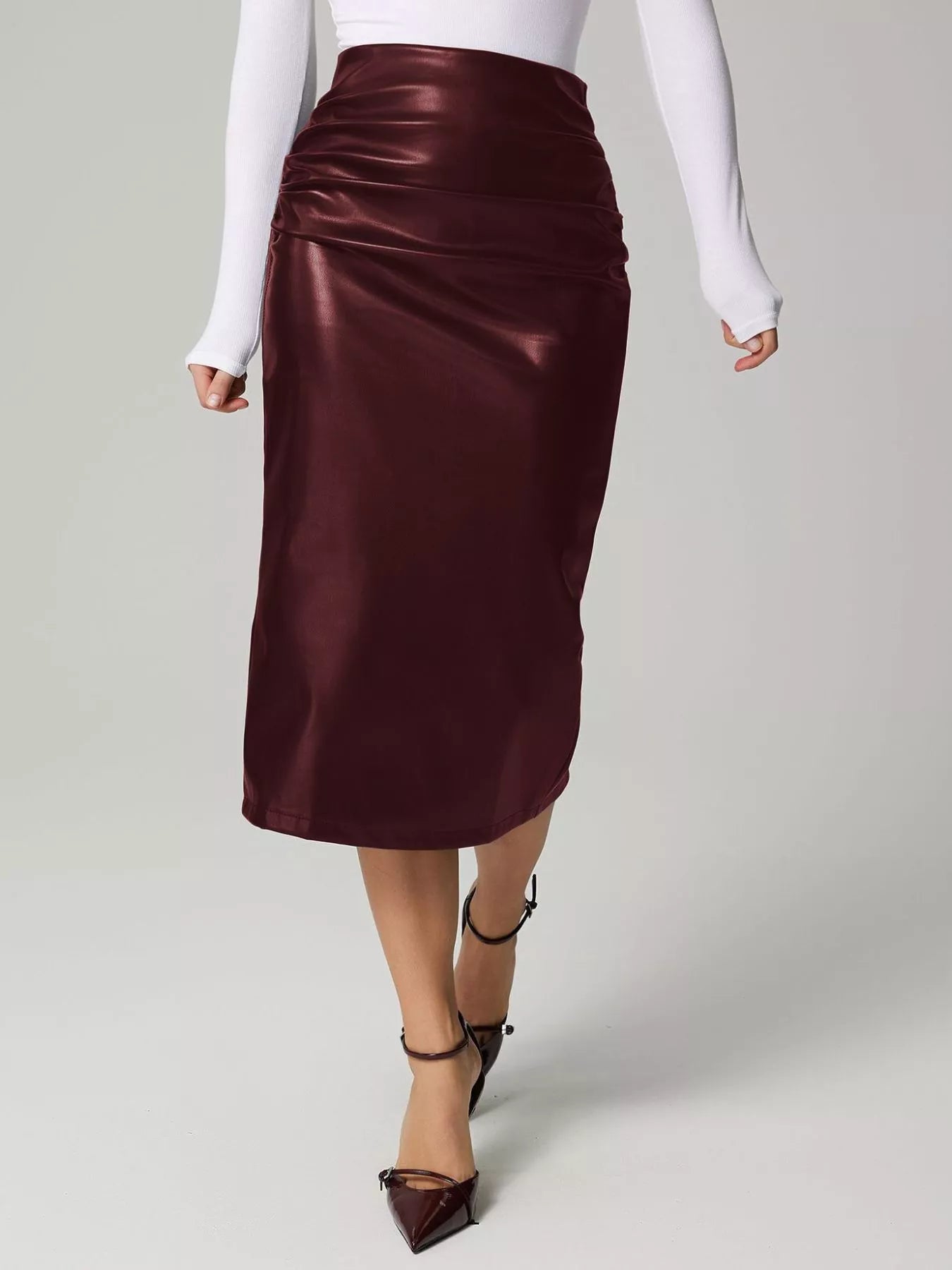 Burgundy satin skirt worn by a person on a light gray background