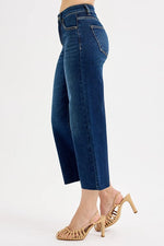 Blue jeans worn by a person on a white background