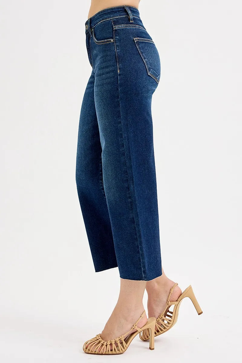 Blue jeans worn by a person on a white background