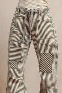 Striped pants with a drawstring on a beige background