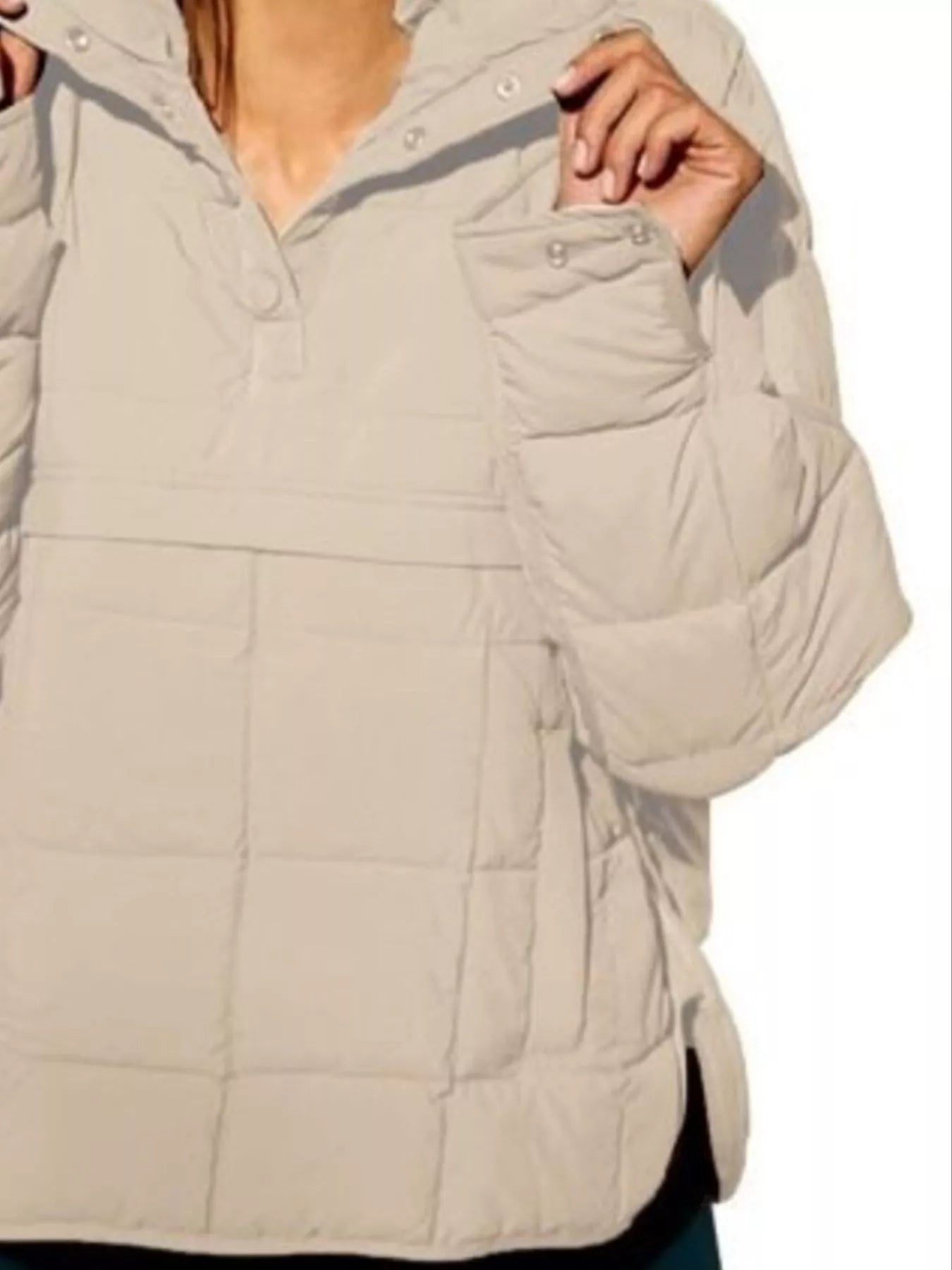 Beige puffer jacket with a hood on a plain background