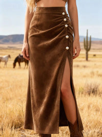 Person wearing a brown suede skirt with button details in a desert setting