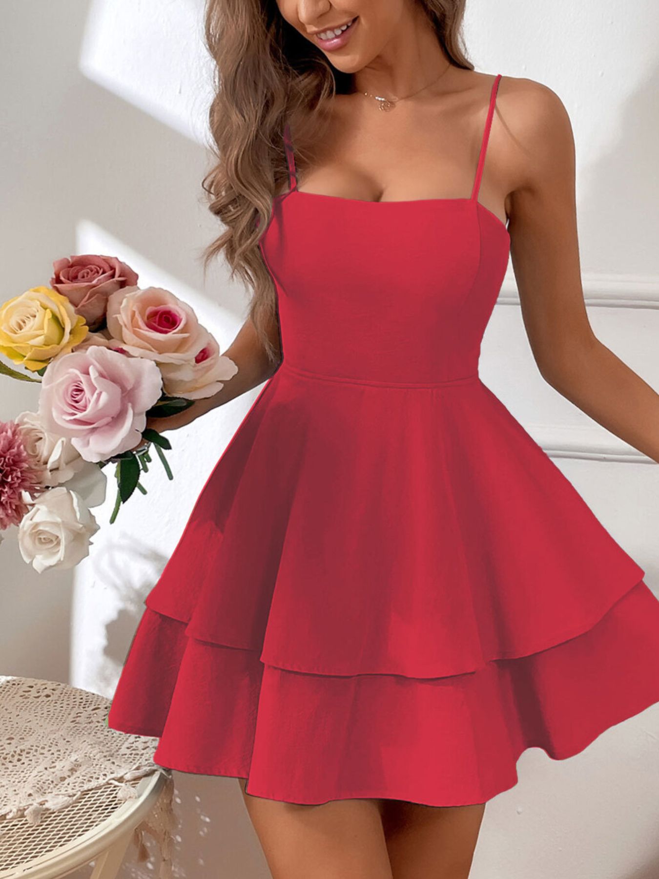 Red dress worn by a person with flowers in the background