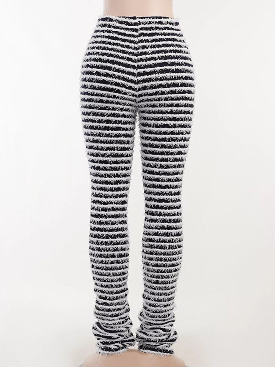 Black and white horizontally striped knit leggings shown on a model from the back, against a plain white background.