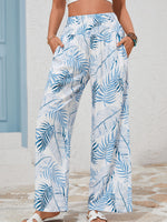 Person wearing blue and white leaf-patterned pants with a neutral background