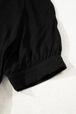 Close-up of a black jacket on a light gray background