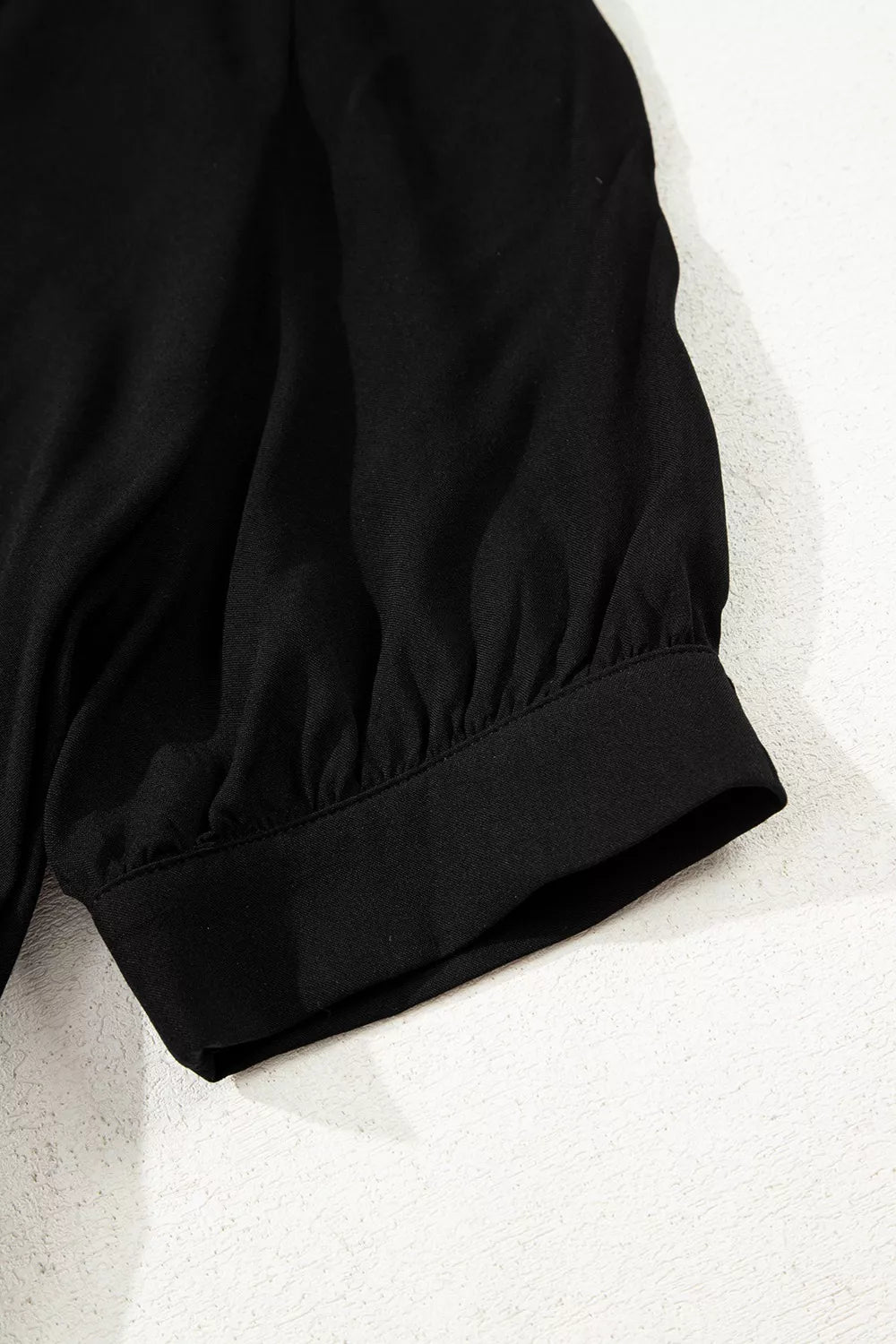 Close-up of a black jacket on a light gray background