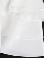 Close-up of a white skirt with a black waistband