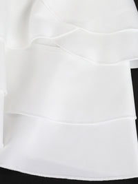 Close-up of a white skirt with a black waistband