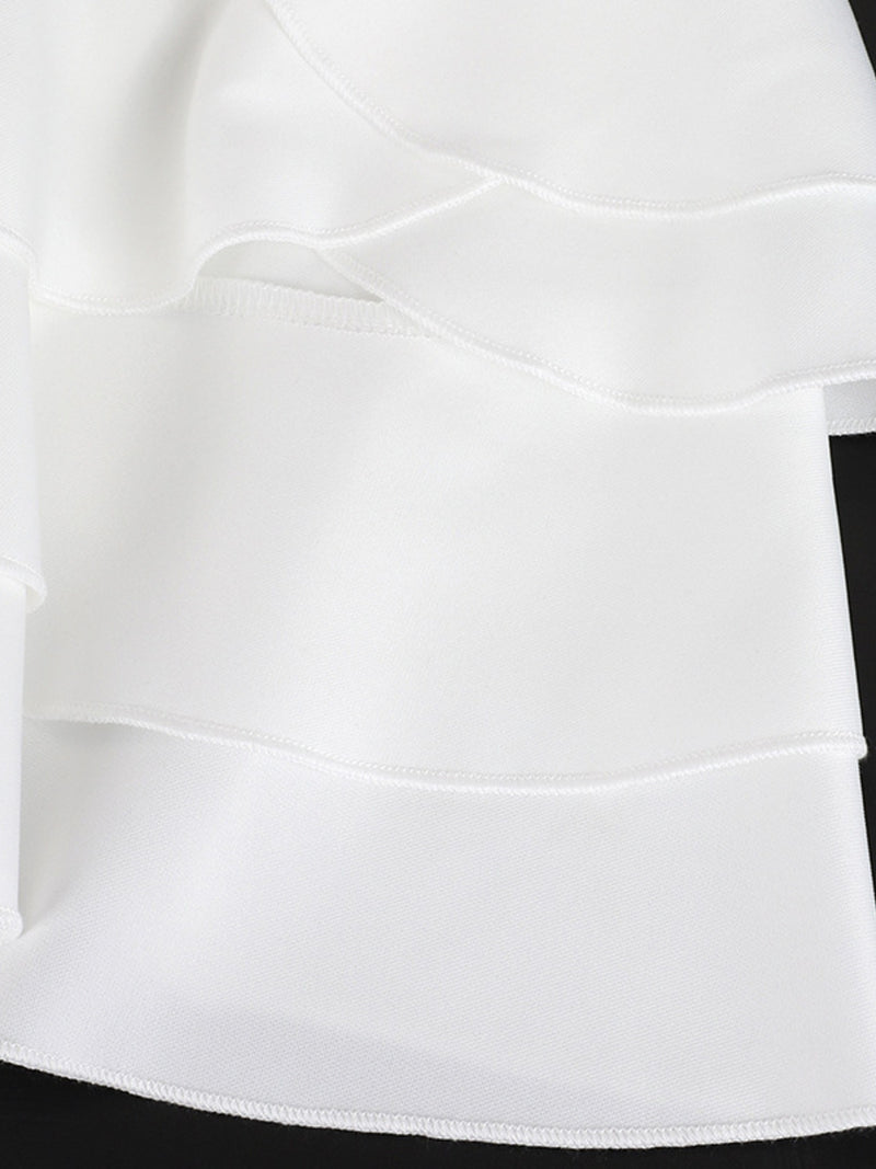 Close-up of a white skirt with a black waistband