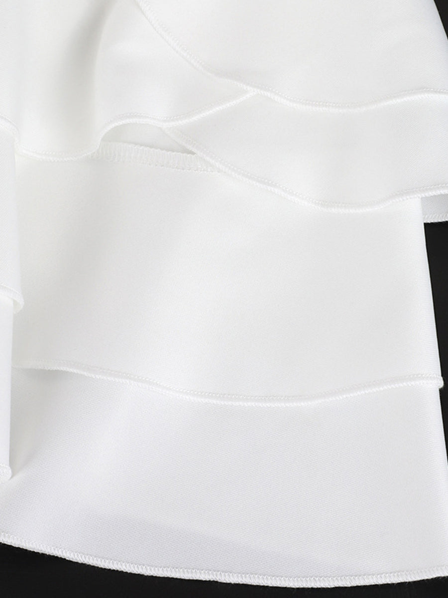 Close-up of a white skirt with a black waistband