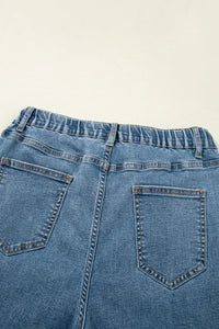 Close-up of blue denim jeans on a beige background