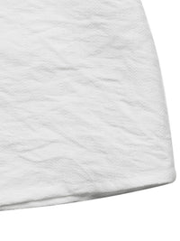 Close-up of a textured white fabric corner on a white background