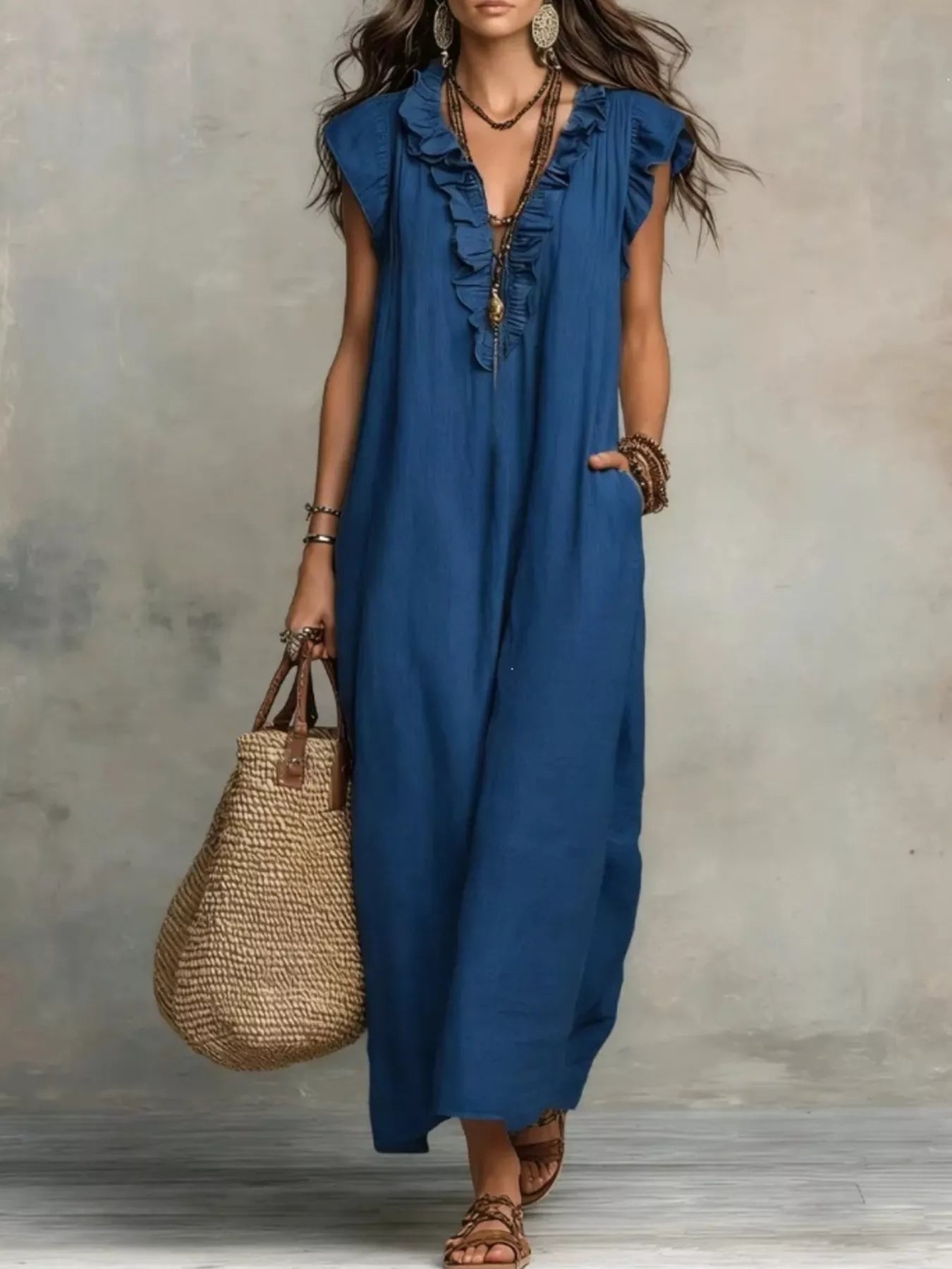 Woman wearing a blue dress holding a straw bag against a neutral background