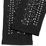 Black leggings with silver bead embellishments on a white background