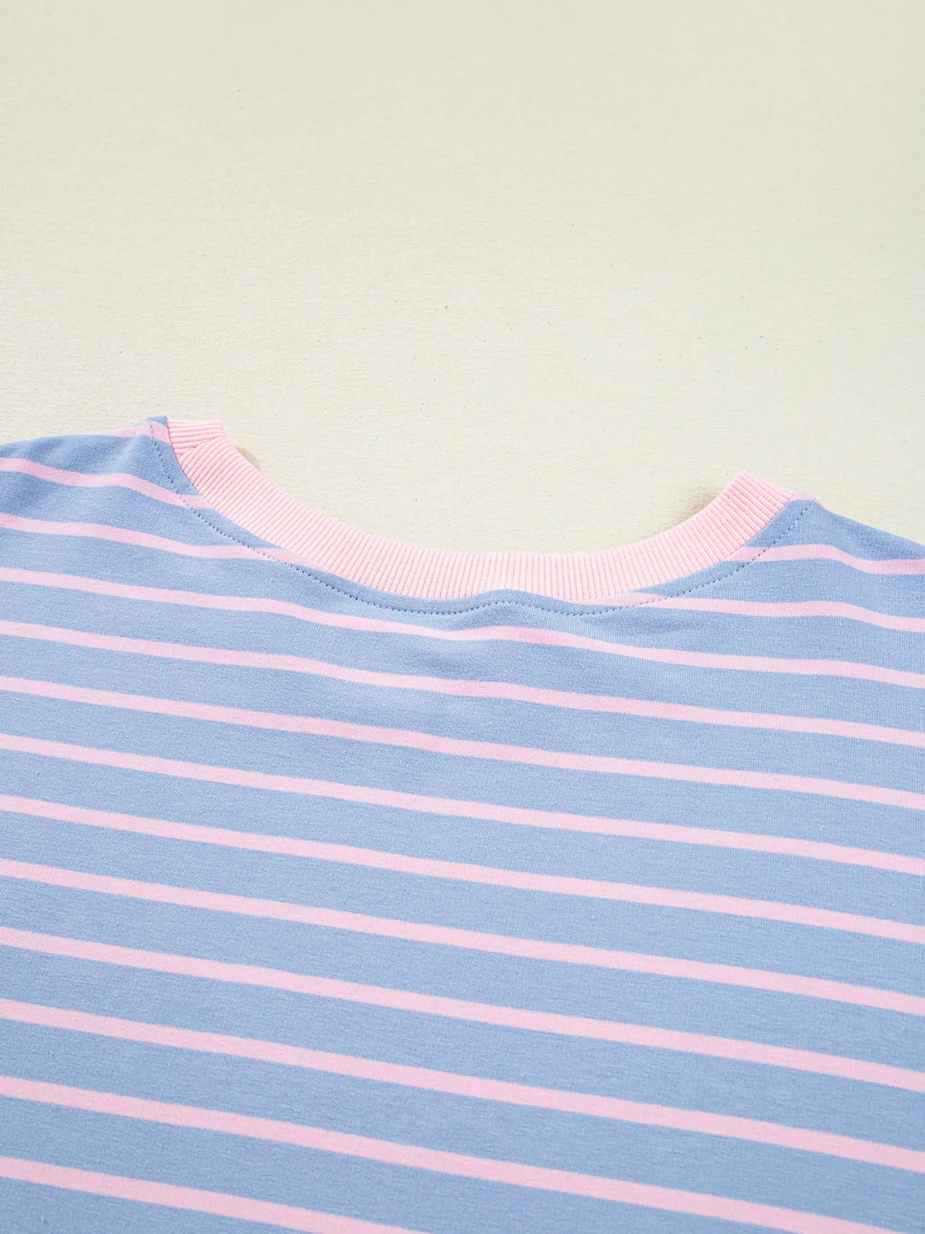 Close-up of a blue and pink striped fabric with a plain background