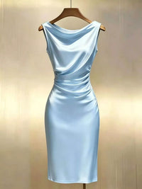 Light blue dress on a wooden hanger against a beige background