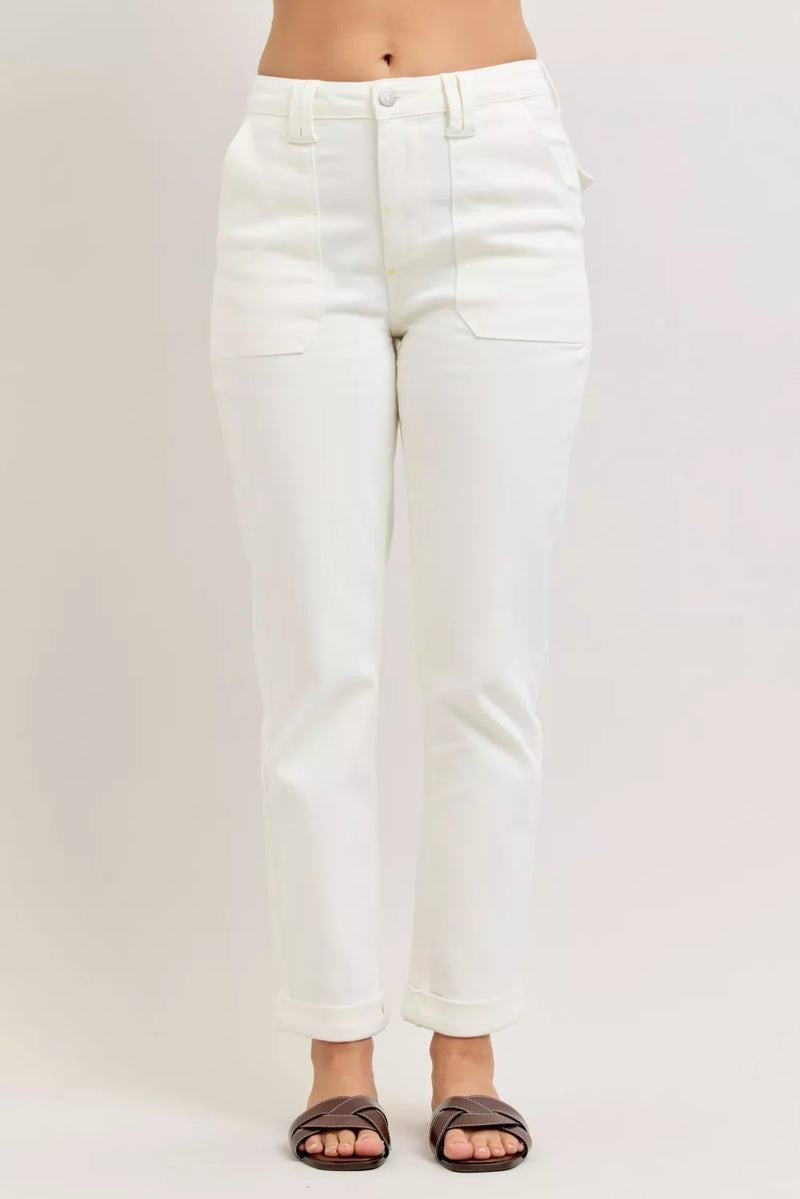 White jeans worn by a person on a plain background