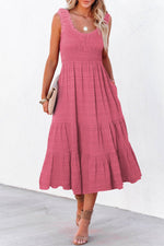 Woman wearing a pink dress with a white background