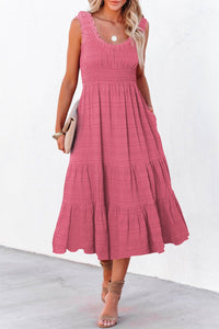 Woman wearing a pink dress with a white background