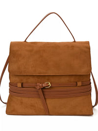 Brown suede handbag with a strap on a white background