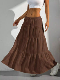 Brown tiered skirt worn by a person on a plain background