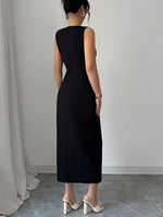 Person wearing a black sleeveless dress against a plain background