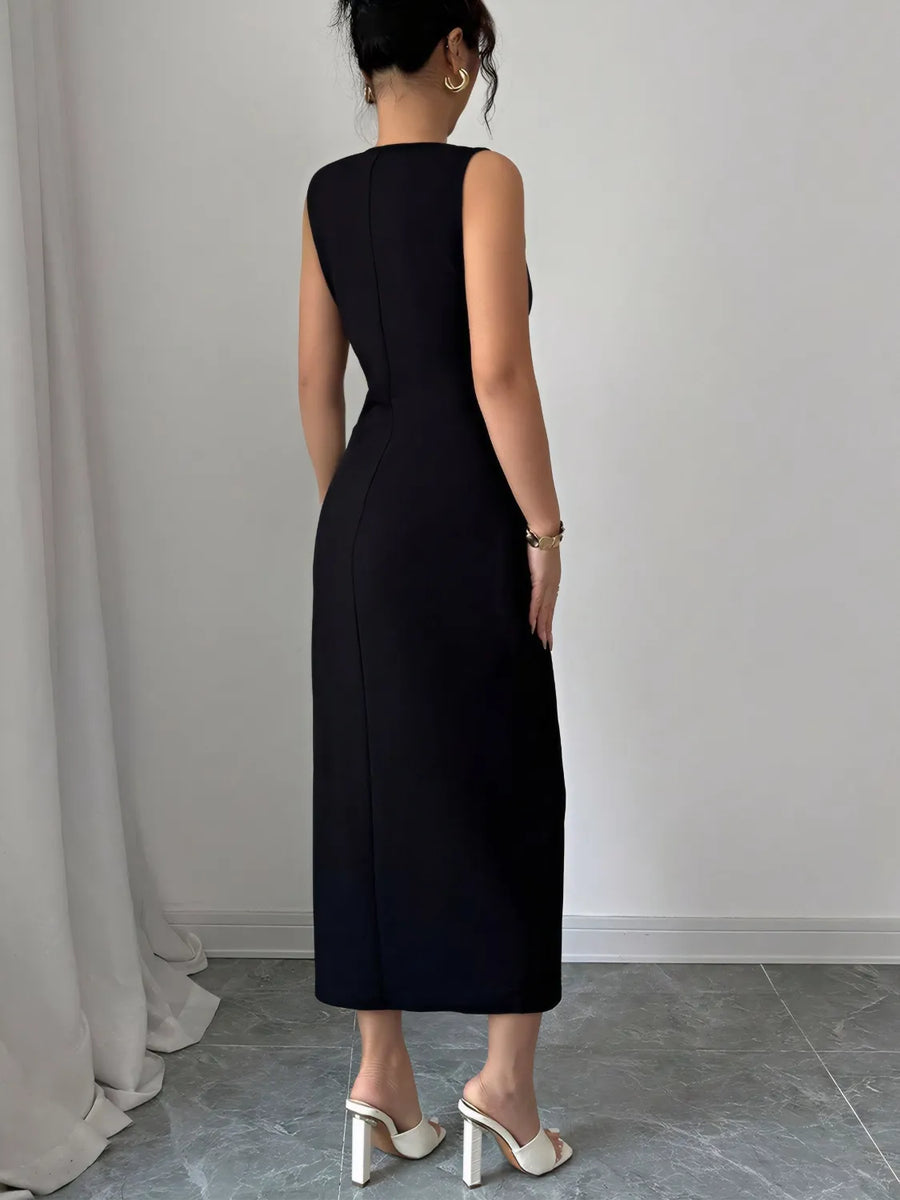 Person wearing a black sleeveless dress against a plain background