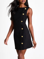 Black dress with gold buttons worn by a model on a white background