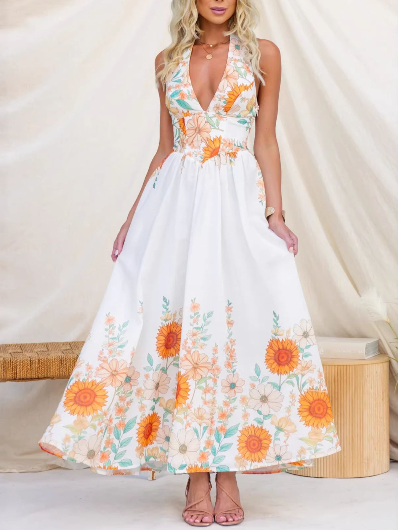 Woman wearing a floral dress with orange flowers on a white background