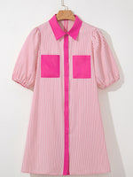 Pink and white striped shirt with pink accents on a hanger against a white background