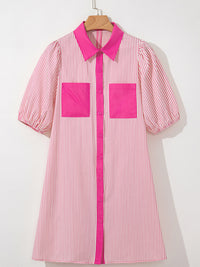 Pink and white striped shirt with pink accents on a hanger against a white background