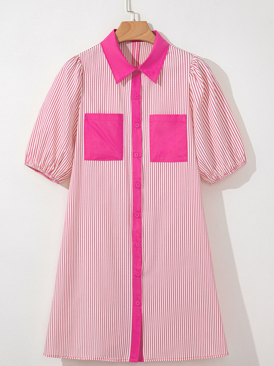 Pink and white striped shirt with pink accents on a hanger against a white background
