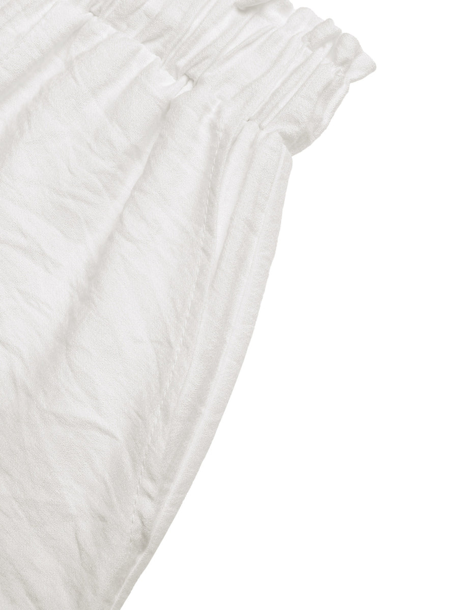 Close-up of textured white fabric on a white background