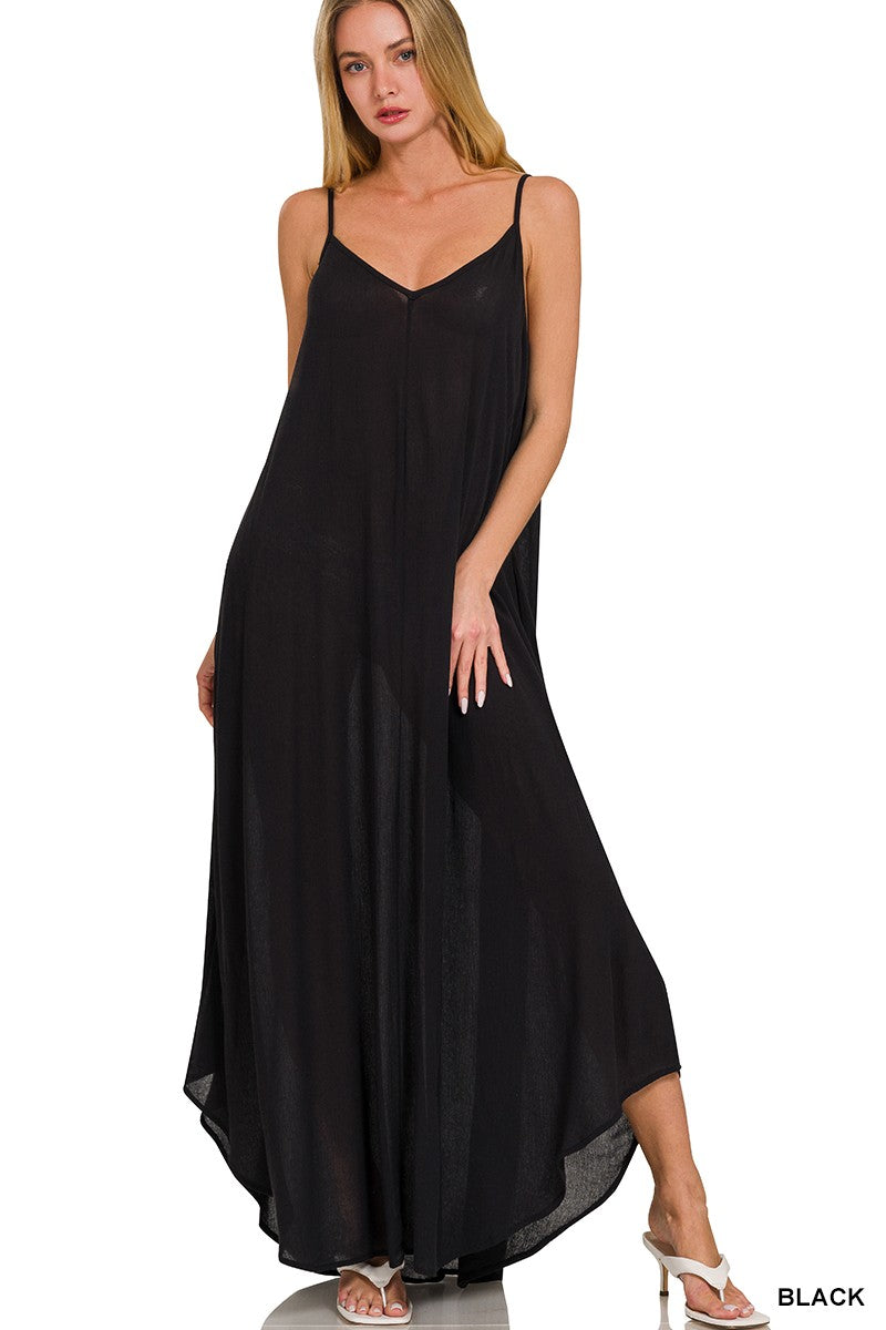 Woman wearing a black slip dress on a white background
