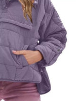 Purple quilted jacket worn by a person on a white background