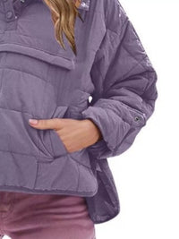 Purple quilted jacket worn by a person on a white background