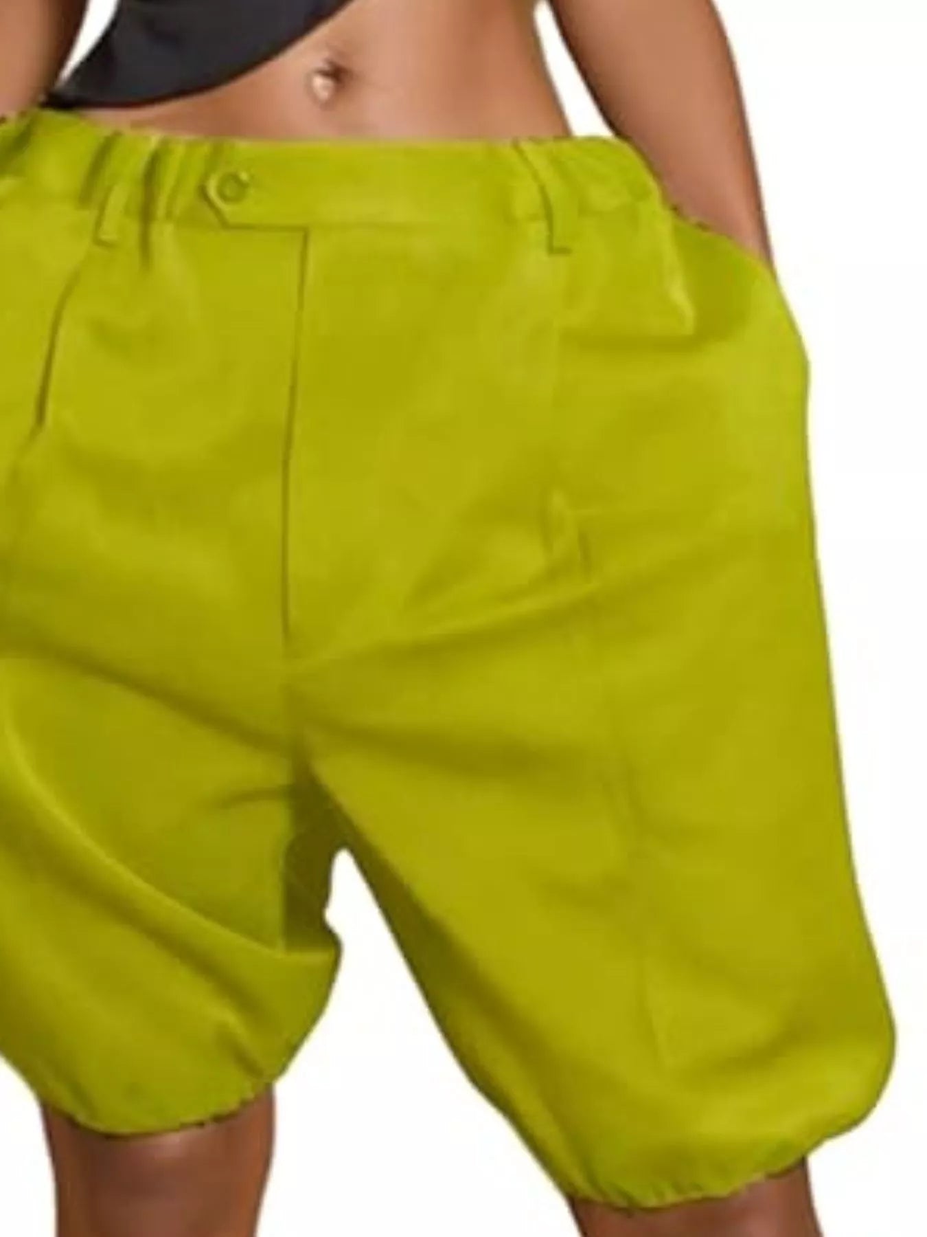 Person wearing bright green shorts on a plain background
