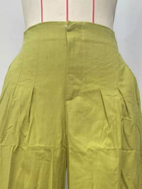 Green pants on a mannequin with a white background