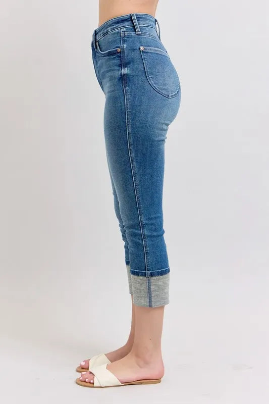 Blue jeans worn by a person on a white background