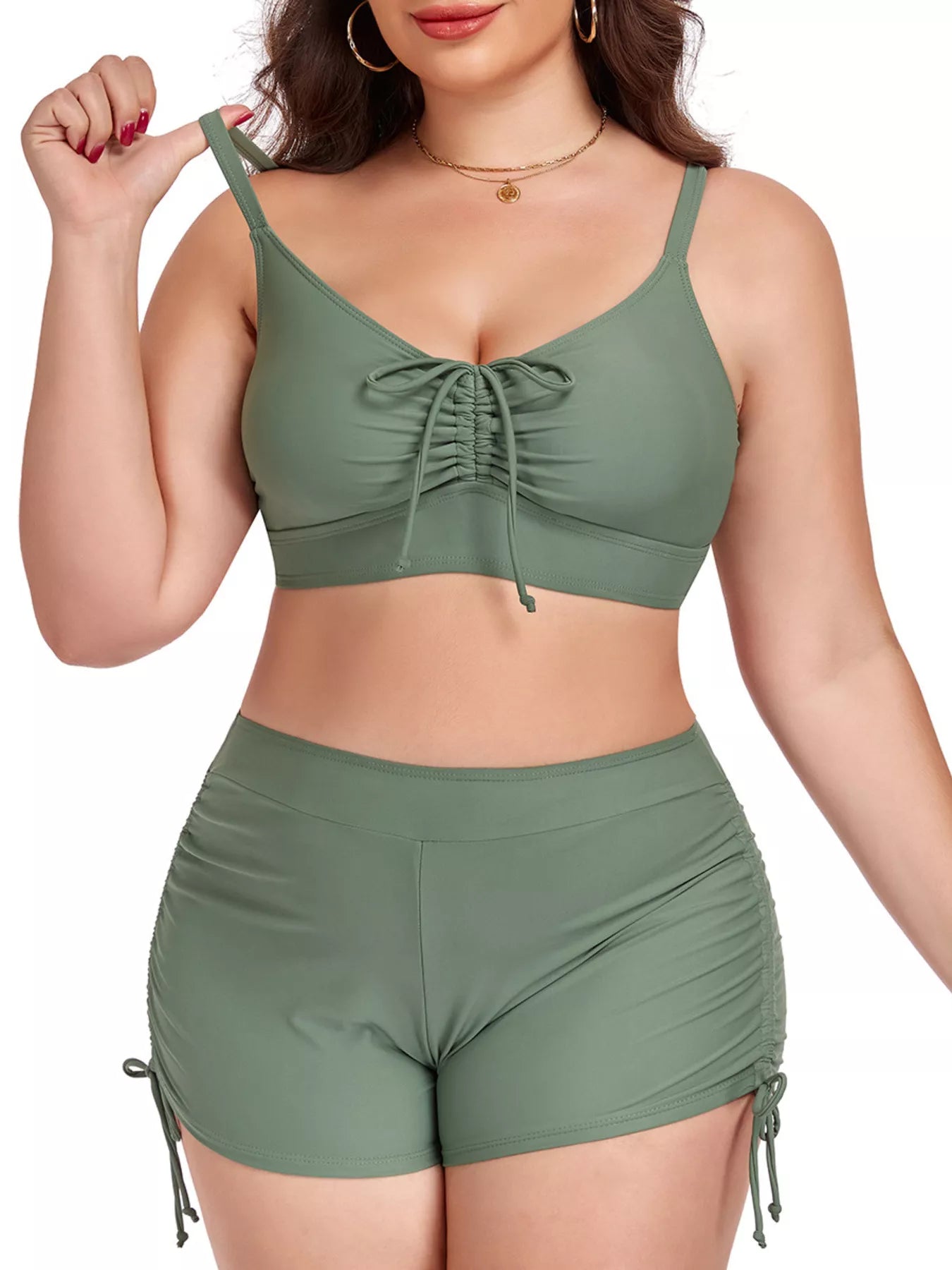 Woman wearing a green bikini set on a white background