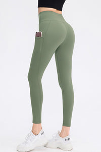 Green leggings with a pocket on a white background